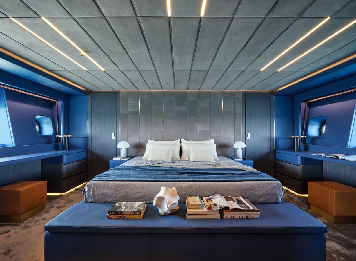 The master stateroom features a luxurious bed with modern decor and ample natural light. aboard AB 110 Yacht for Sale