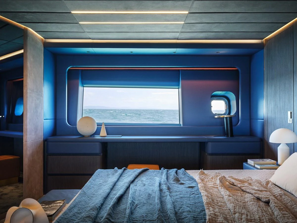 A luxurious stateroom with a large window offering a stunning ocean view. aboard AB 110 Yacht for Sale