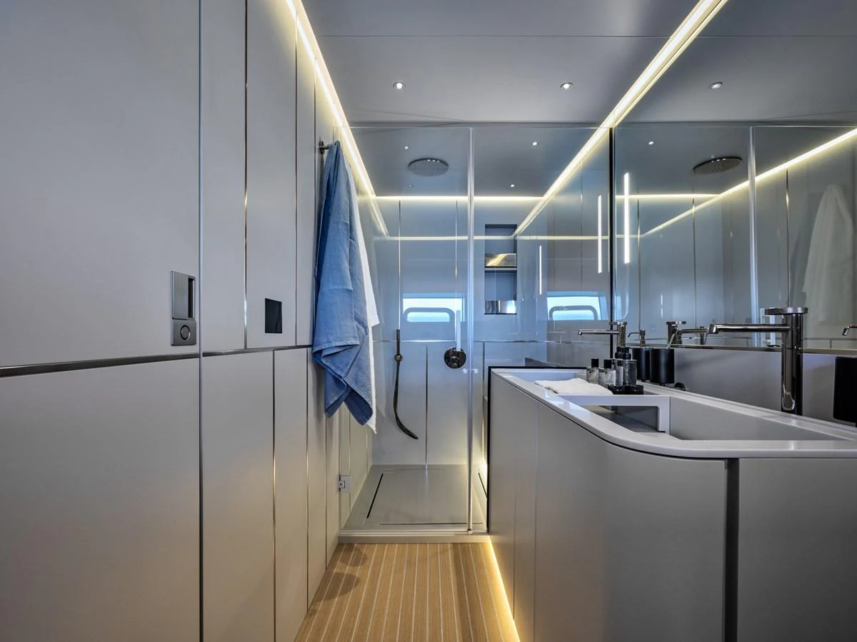 A sleek and modern bathroom with a glass-enclosed shower and elegant fixtures. aboard AB 110 Yacht for Sale