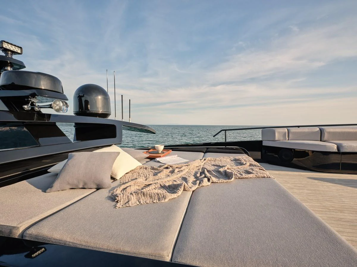 The sundeck offers a luxurious lounging area with plush cushions and a serene ocean view. aboard AB 110 Yacht for Sale