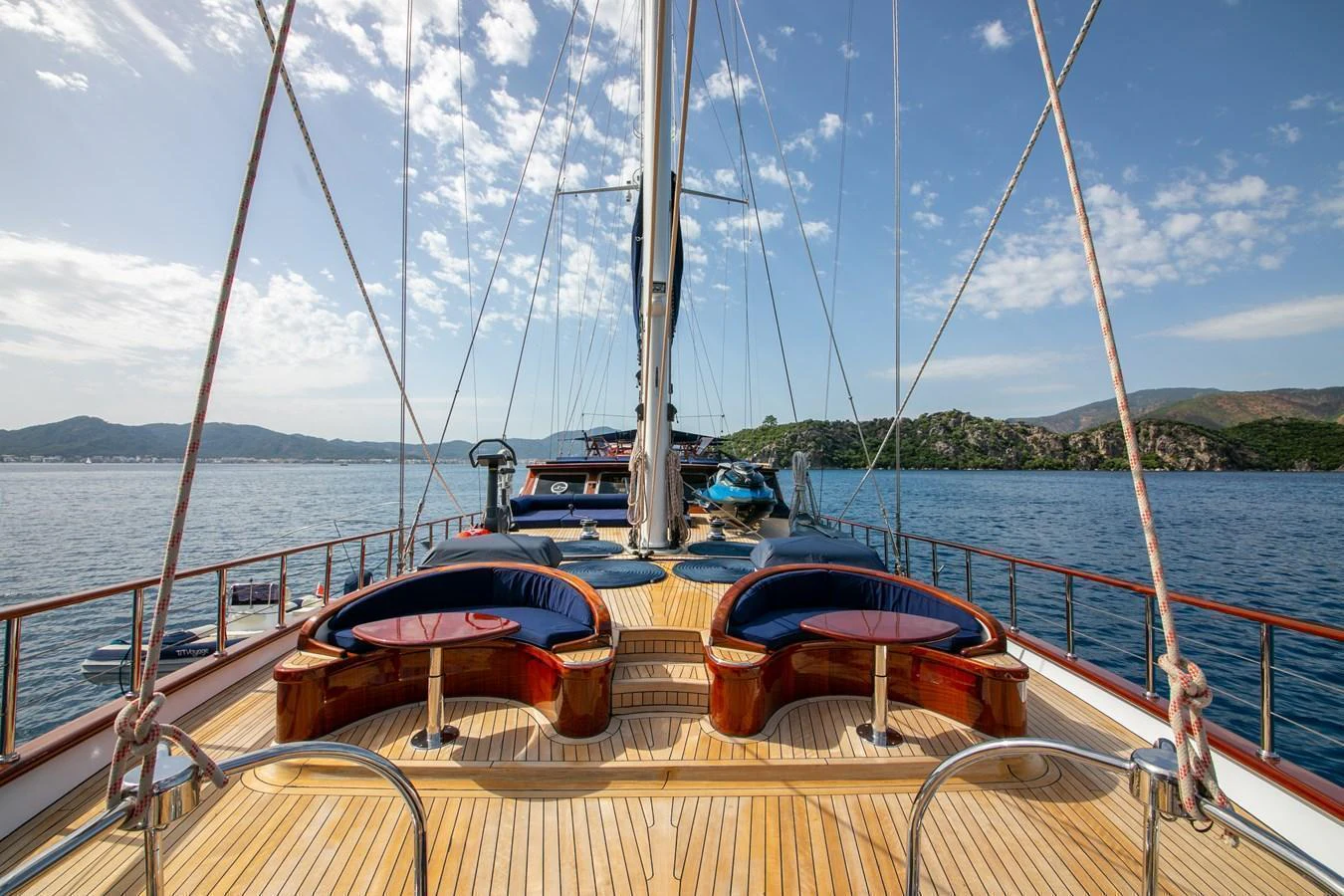 The yacht's aft deck features elegant seating areas with a stunning view of the surrounding waters and landscape. aboard VOYAGE Yacht for Sale