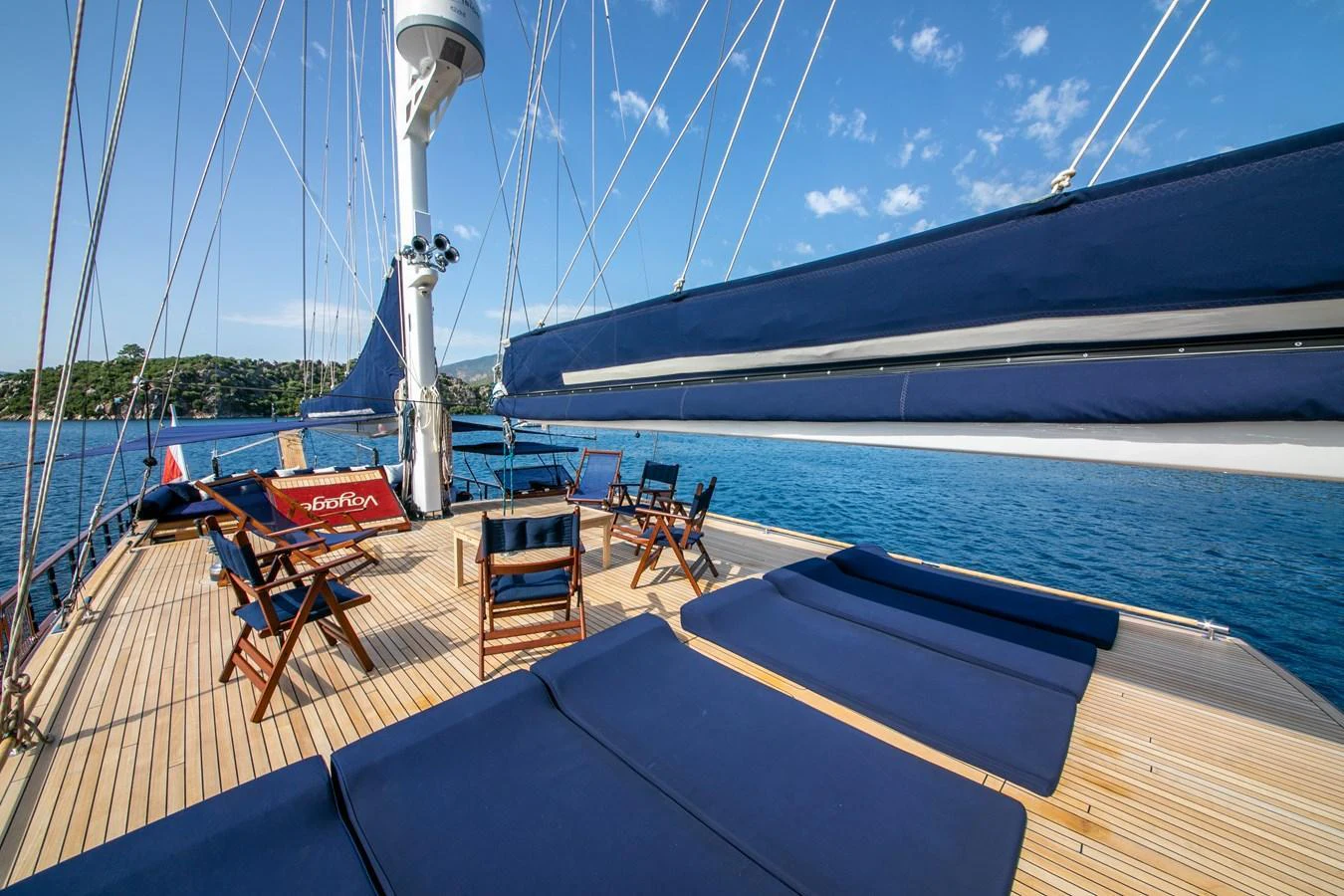 The sundeck offers a relaxing space with lounge chairs and a stunning view of the water. aboard VOYAGE Yacht for Sale
