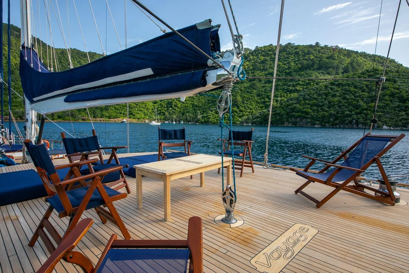 The yacht's deck offers a serene and inviting space with comfortable seating and picturesque views of the surrounding water and greenery. aboard VOYAGE Yacht for Sale