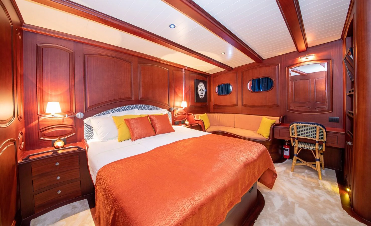 The master stateroom features rich wood paneling and luxurious bedding, creating a warm and inviting atmosphere. aboard VOYAGE Yacht for Sale