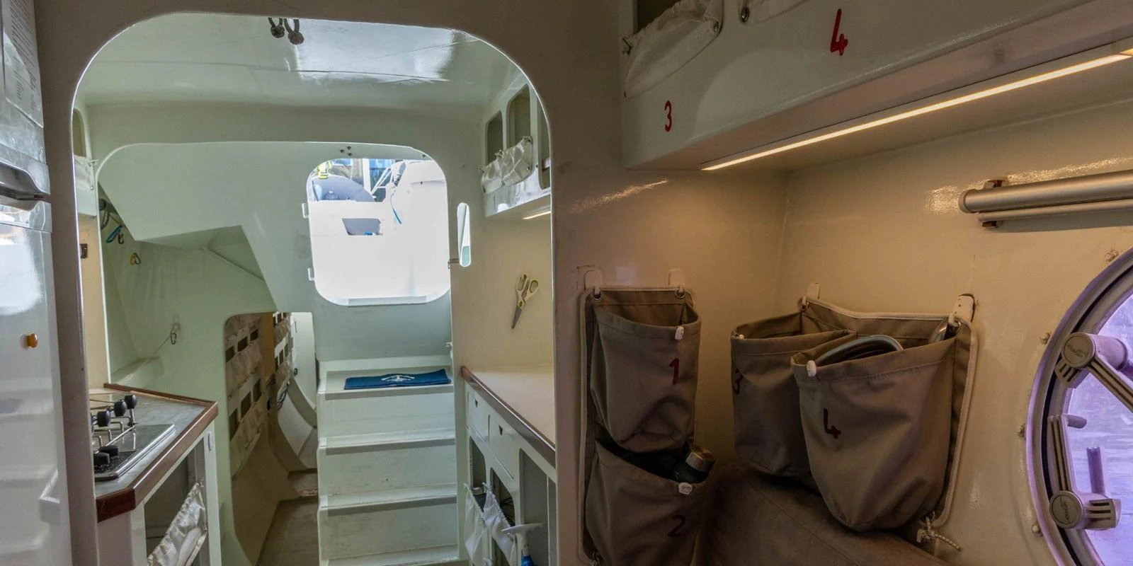 The yacht's interior features a functional and organized workspace with ample storage and a clean design. aboard MAXICAT VICTORIA Yacht for Sale