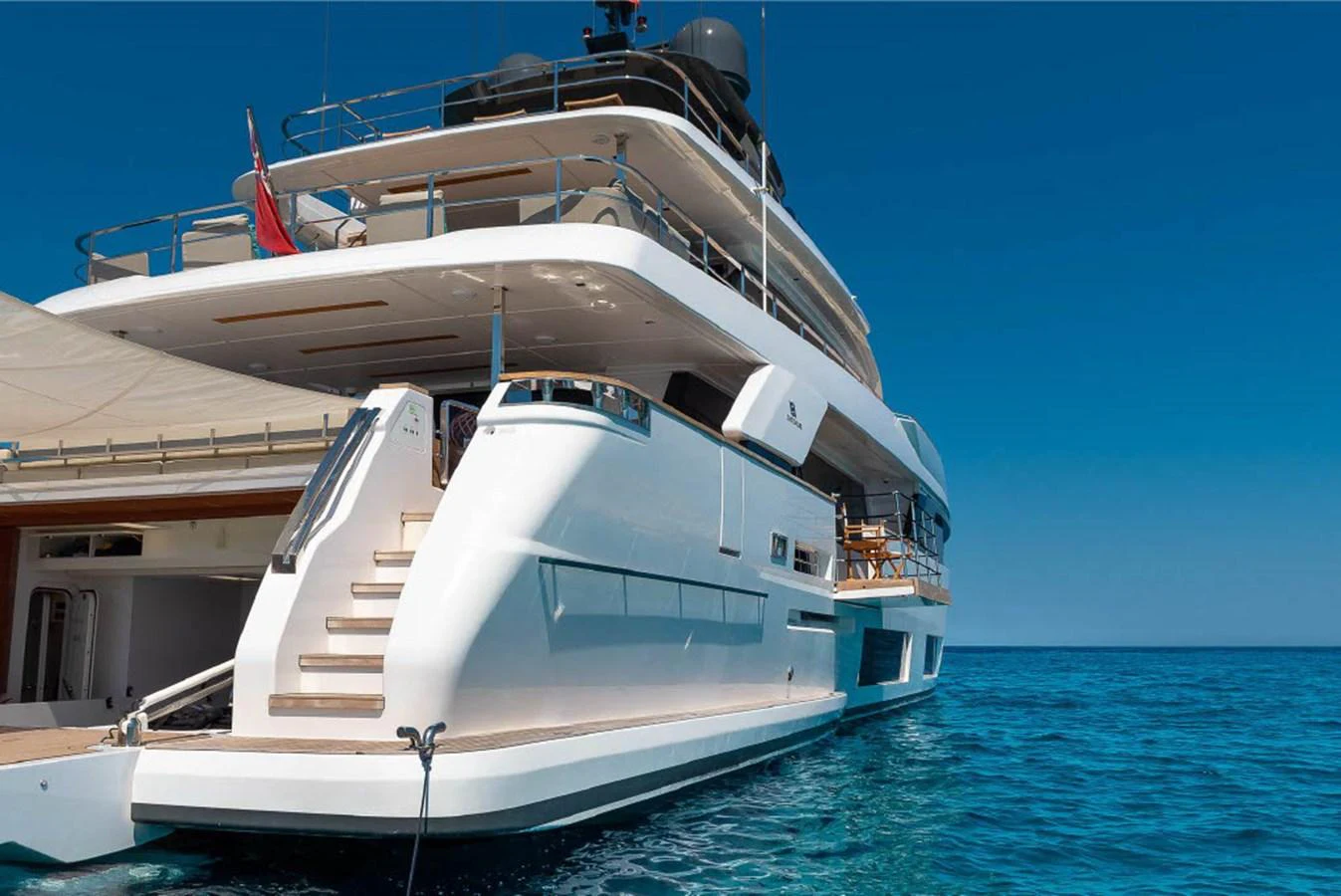 A luxurious yacht anchored in clear blue waters, showcasing its sleek and modern design. aboard ON Yacht for Sale