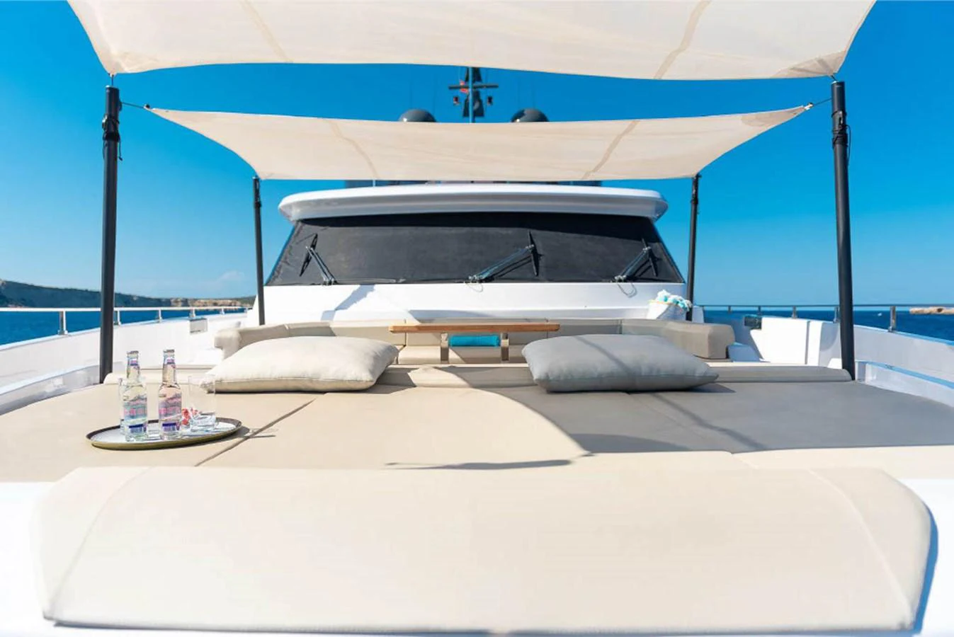 The sundeck offers a luxurious lounging area with comfortable cushions and a shaded canopy. aboard ON Yacht for Sale