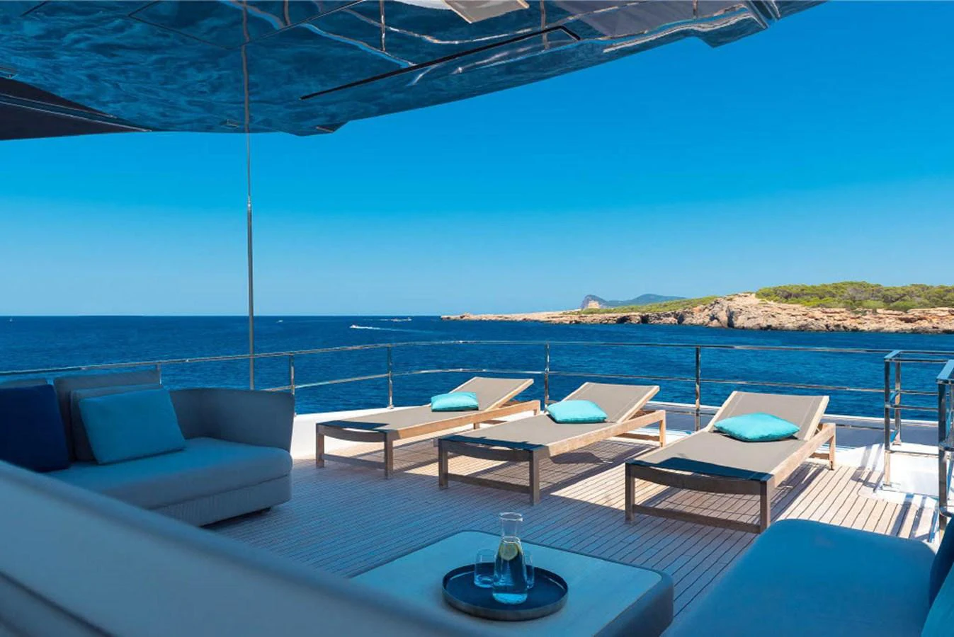 The sundeck offers a serene space with sun loungers and a stunning ocean view. aboard ON Yacht for Sale