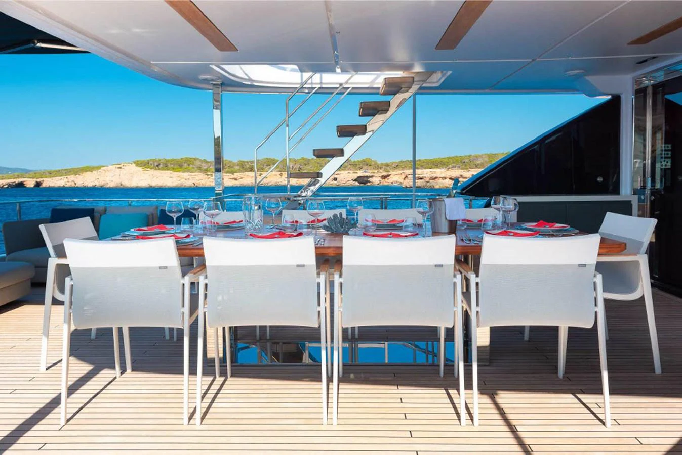 The aft deck features an elegant dining area with a stunning view of the sea. aboard ON Yacht for Sale