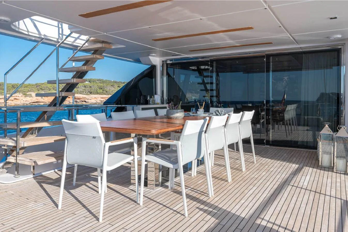 The aft deck features a spacious dining area with a sleek table and modern chairs, perfect for alfresco dining. aboard ON Yacht for Sale