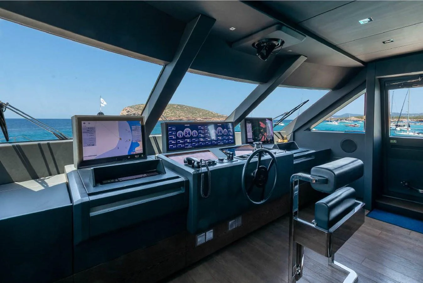 The helm station offers a commanding view with advanced navigation equipment and luxurious seating. aboard ON Yacht for Sale