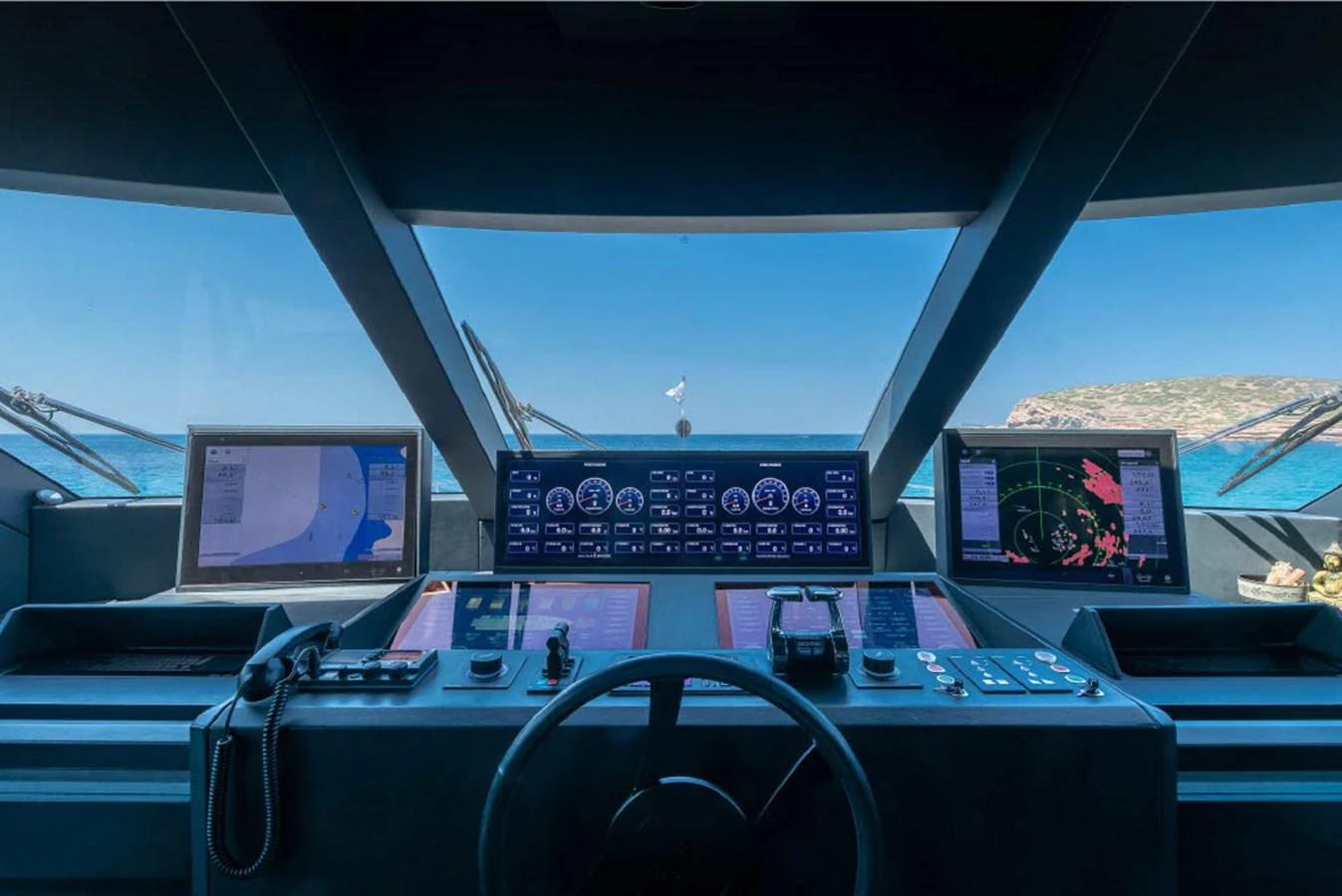The helm station offers a commanding view with advanced navigation systems and multiple displays. aboard ON Yacht for Sale