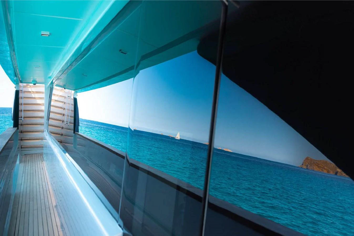 A sleek exterior walkway with a stunning ocean view reflected on the yacht's glossy surface. aboard ON Yacht for Sale