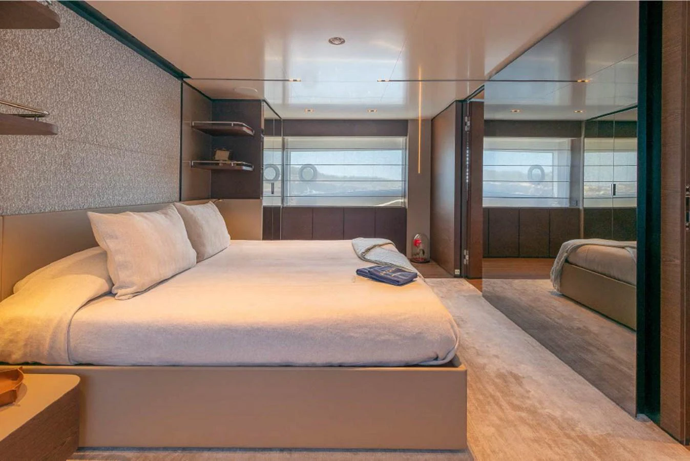 The master stateroom features a spacious bed with elegant decor and ample natural light. aboard ON Yacht for Sale