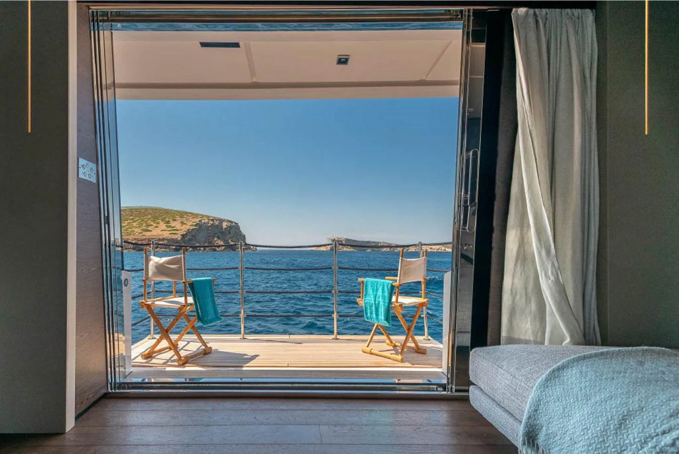 A serene cabin opens up to a private balcony with stunning ocean views. aboard ON Yacht for Sale