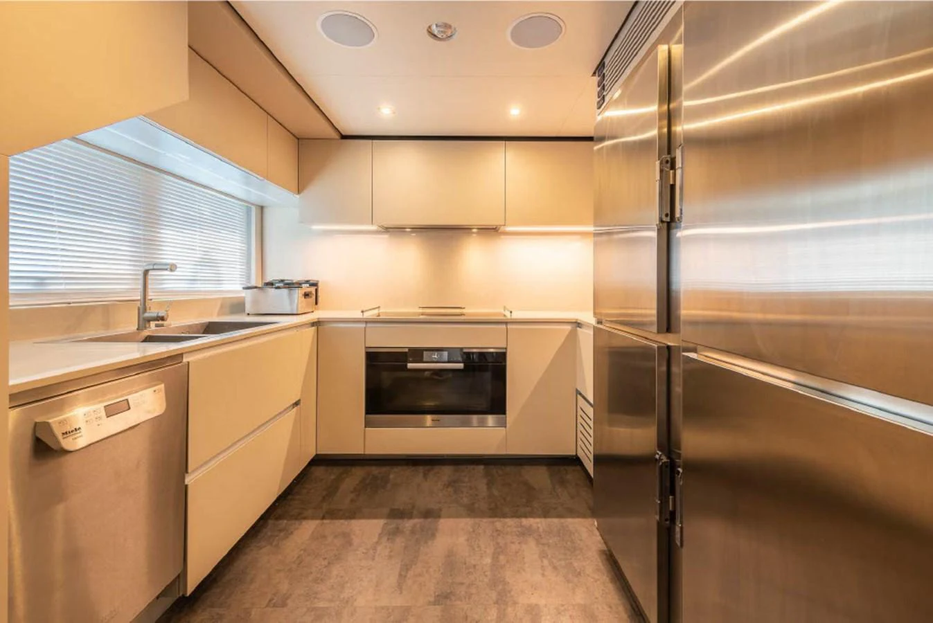 The yacht's galley features modern appliances and sleek cabinetry, creating a stylish and functional cooking space. aboard ON Yacht for Sale