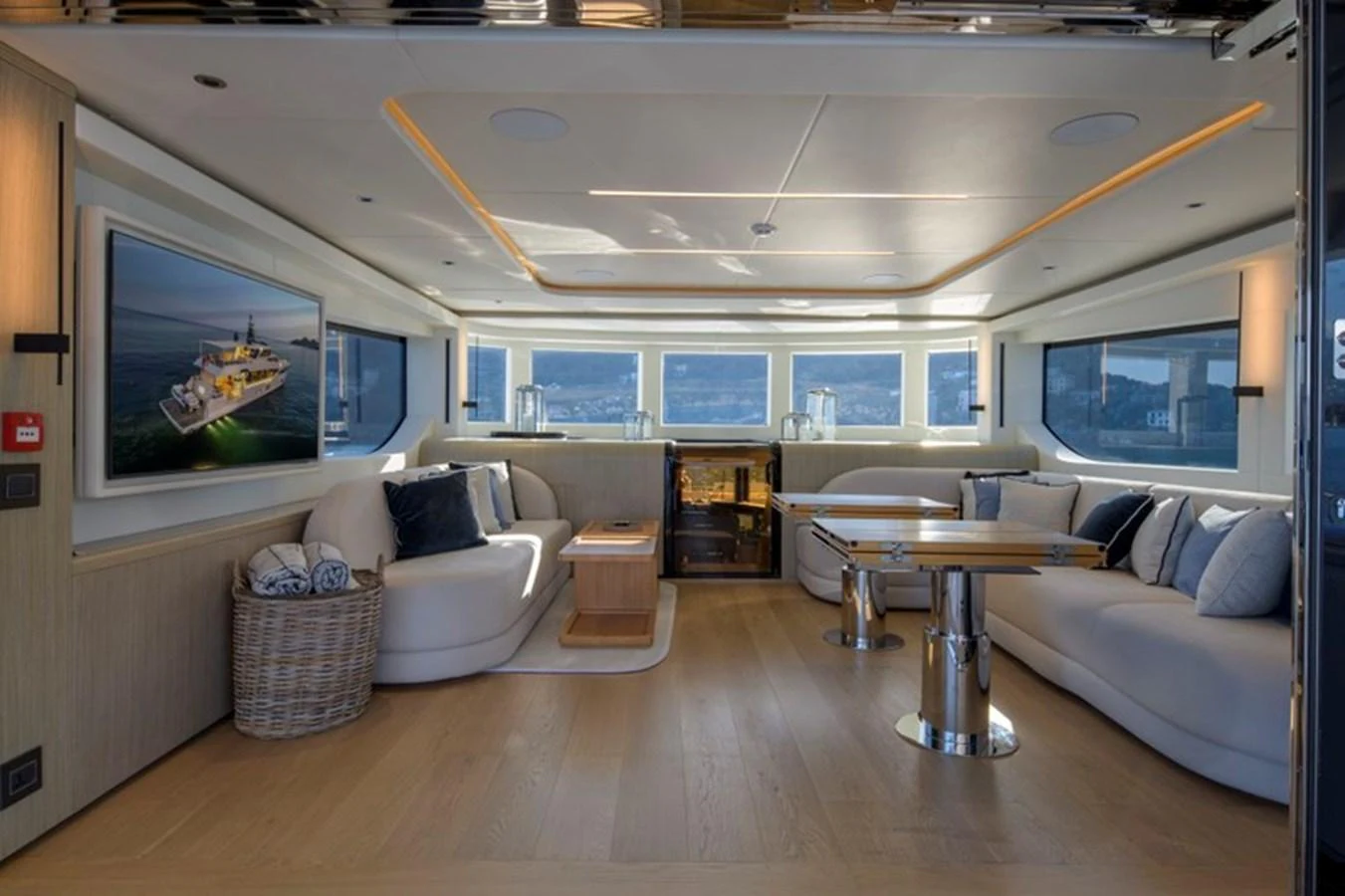 The yacht's salon features luxurious seating, a large flat-screen TV, and panoramic windows offering stunning views. aboard BIG M Yacht for Sale