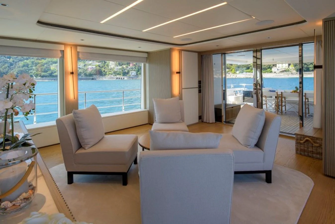 The salon offers a spacious and elegant seating area with large windows providing stunning views of the water. aboard BIG M Yacht for Sale