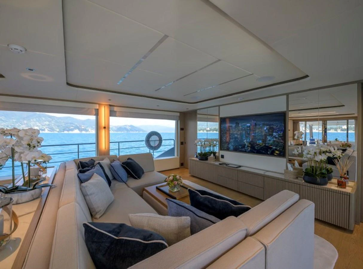 The yacht's salon features plush seating and large windows offering panoramic ocean views. aboard BIG M Yacht for Sale