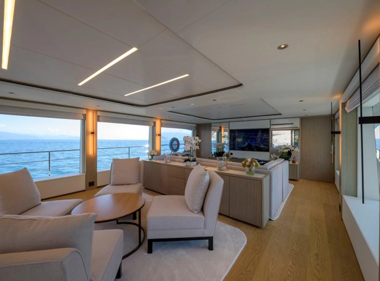 The yacht's salon features elegant seating with panoramic ocean views. aboard BIG M Yacht for Sale