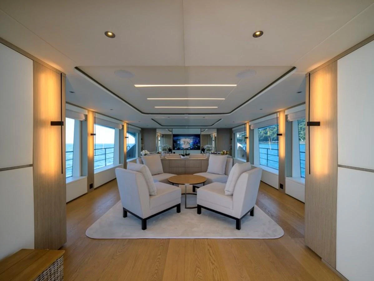 The yacht's salon features a spacious and elegant seating area with modern decor and large windows offering panoramic views. aboard BIG M Yacht for Sale
