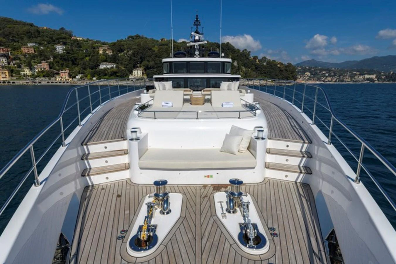 The yacht's foredeck features a spacious lounging area with plush seating and a stunning view of the surrounding waters. aboard BIG M Yacht for Sale