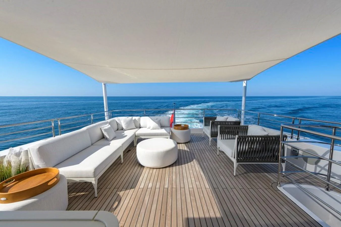 The sundeck offers a luxurious space with comfortable seating and stunning ocean views. aboard BIG M Yacht for Sale