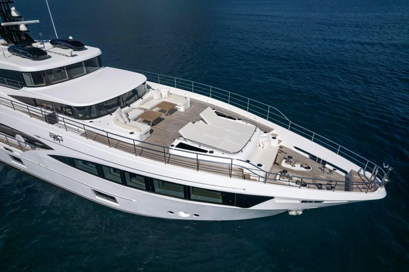 The yacht's foredeck features spacious sunbathing areas and elegant design elements, perfect for relaxation. aboard BIG M Yacht for Sale