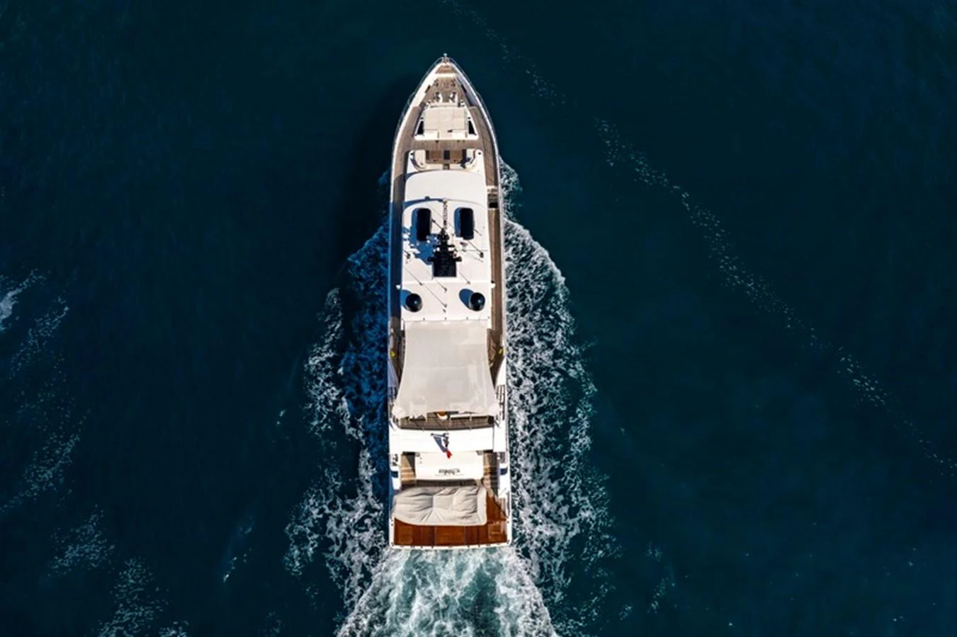 Aerial view of a yacht cruising through deep blue waters. aboard BIG M Yacht for Sale
