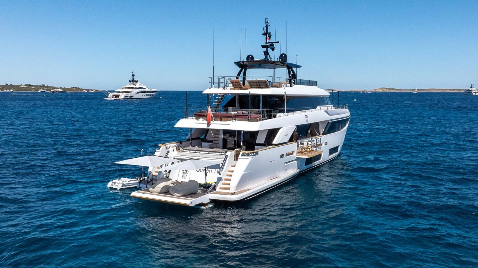 A luxurious yacht anchored in clear blue waters, showcasing its sleek design and spacious decks. aboard QUEEN J III Yacht for Sale