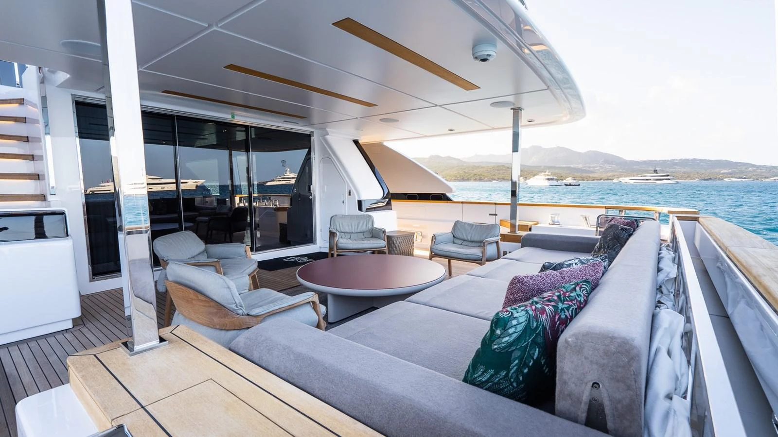 The aft deck features a spacious lounging area with comfortable seating and a stunning view of the sea. aboard QUEEN J III Yacht for Sale