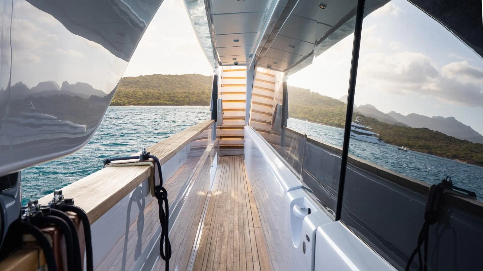 The sleek side deck of the yacht offers a stunning view of the surrounding waters and landscape. aboard QUEEN J III Yacht for Sale