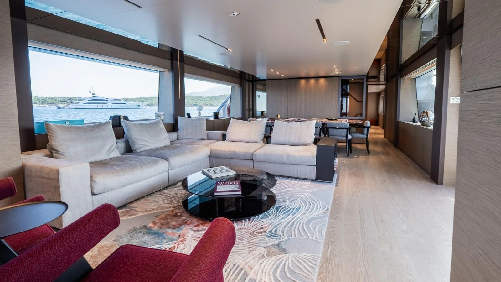 The spacious salon features luxurious seating with panoramic views through large windows. aboard QUEEN J III Yacht for Sale