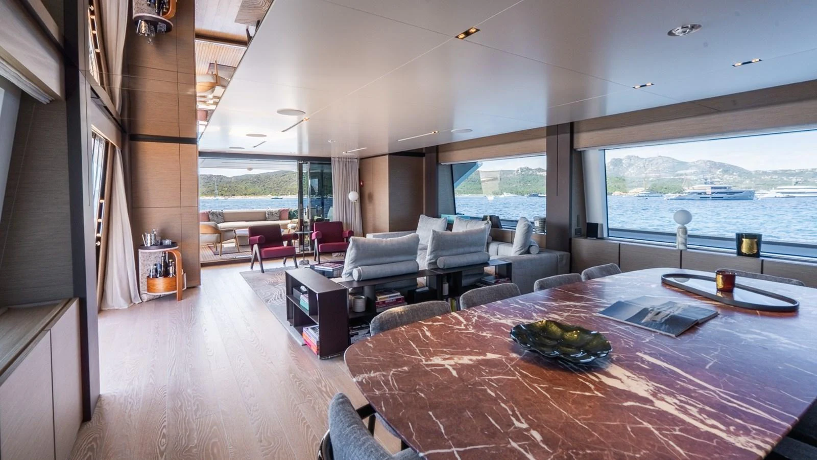 The spacious salon features elegant furnishings and panoramic windows offering stunning views. aboard QUEEN J III Yacht for Sale