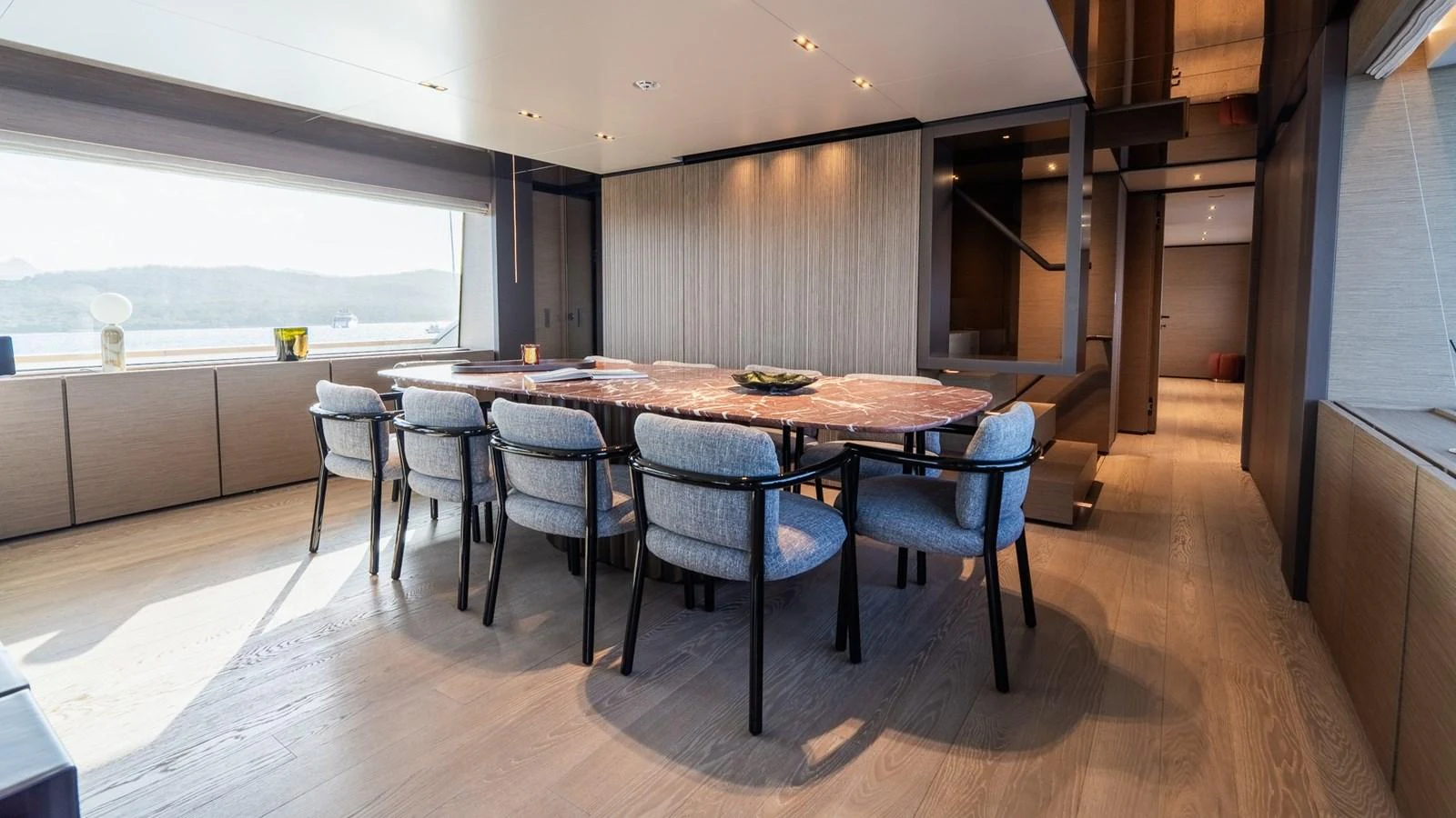 The yacht's dining area features a large table with comfortable seating and ample natural light. aboard QUEEN J III Yacht for Sale