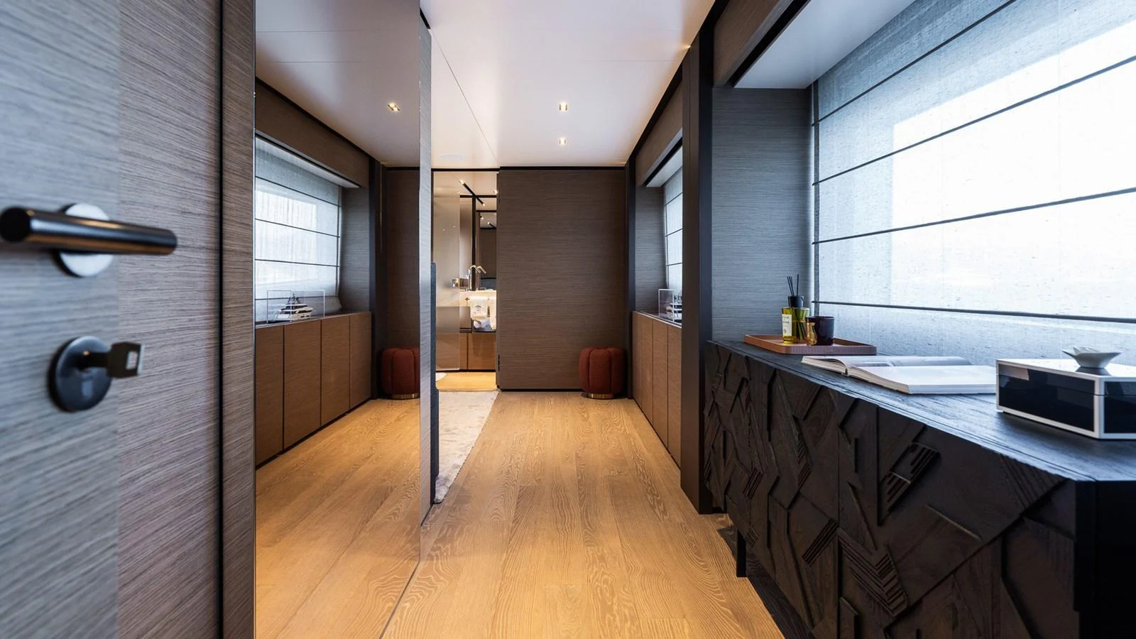 A luxurious hallway with modern decor and ample natural light. aboard QUEEN J III Yacht for Sale