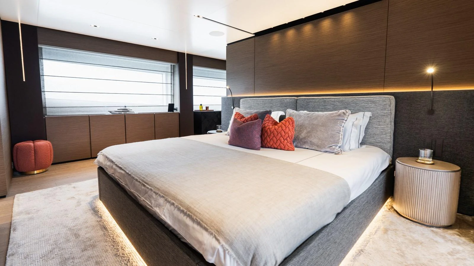 The master stateroom features a luxurious bed with modern decor and ambient lighting. aboard QUEEN J III Yacht for Sale