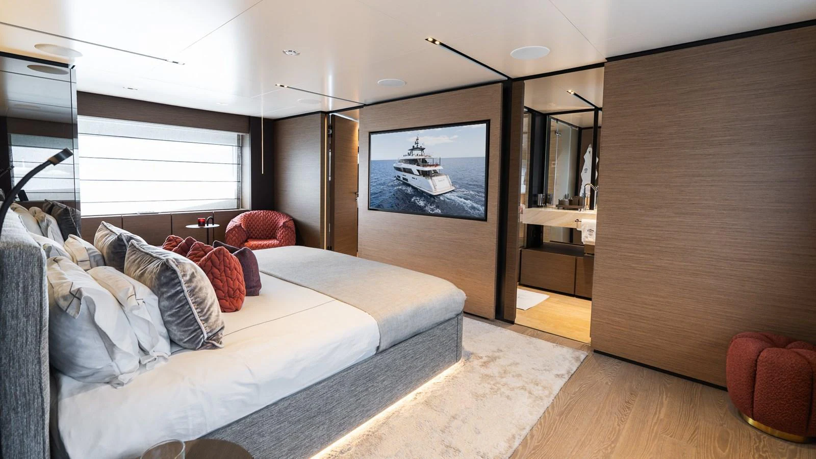 The master stateroom features a luxurious bed, modern decor, and an ensuite bathroom. aboard QUEEN J III Yacht for Sale