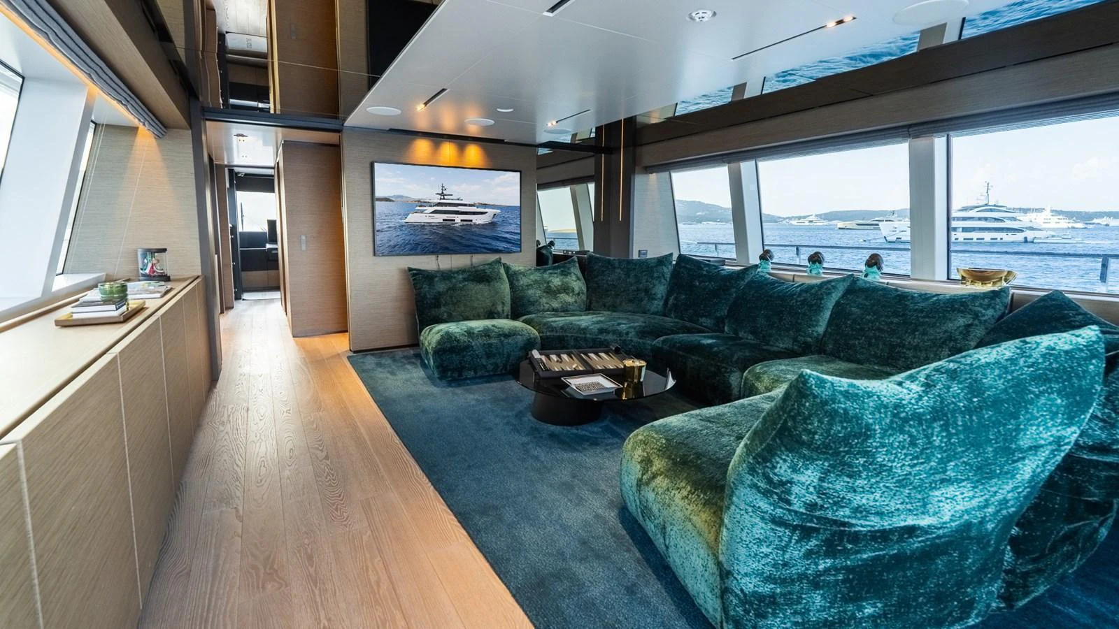 The salon features plush seating and large windows offering panoramic views. aboard QUEEN J III Yacht for Sale