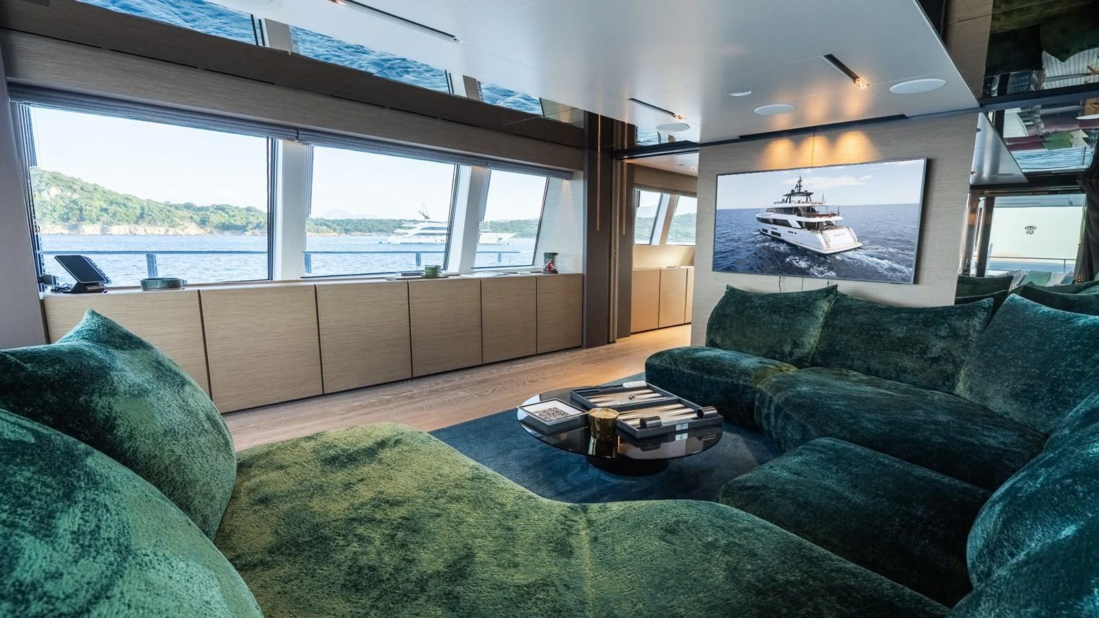 The salon offers a luxurious and spacious seating area with panoramic views of the sea. aboard QUEEN J III Yacht for Sale