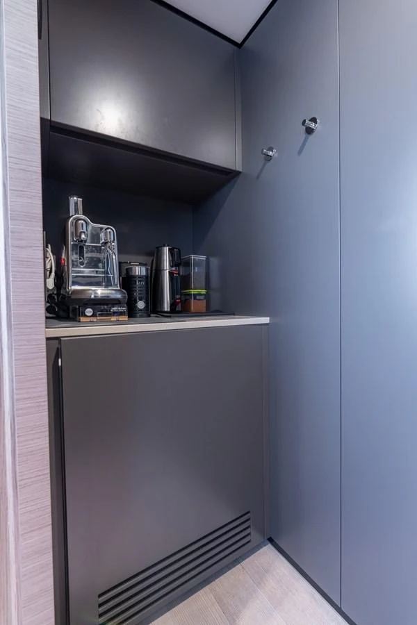A compact and modern galley area with sleek cabinetry and essential appliances. aboard QUEEN J III Yacht for Sale