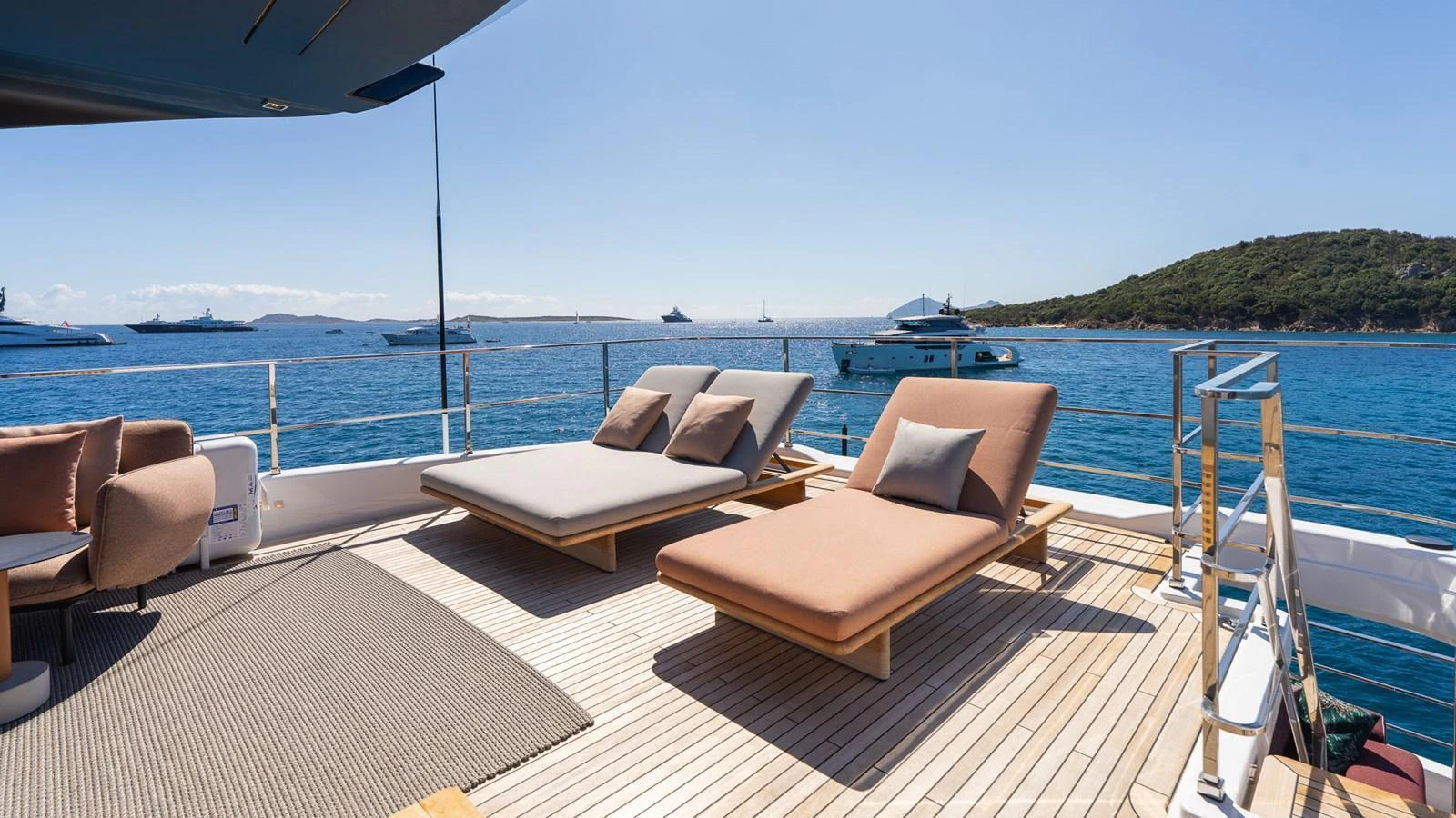 The sundeck offers a serene space with comfortable loungers and stunning sea views. aboard QUEEN J III Yacht for Sale