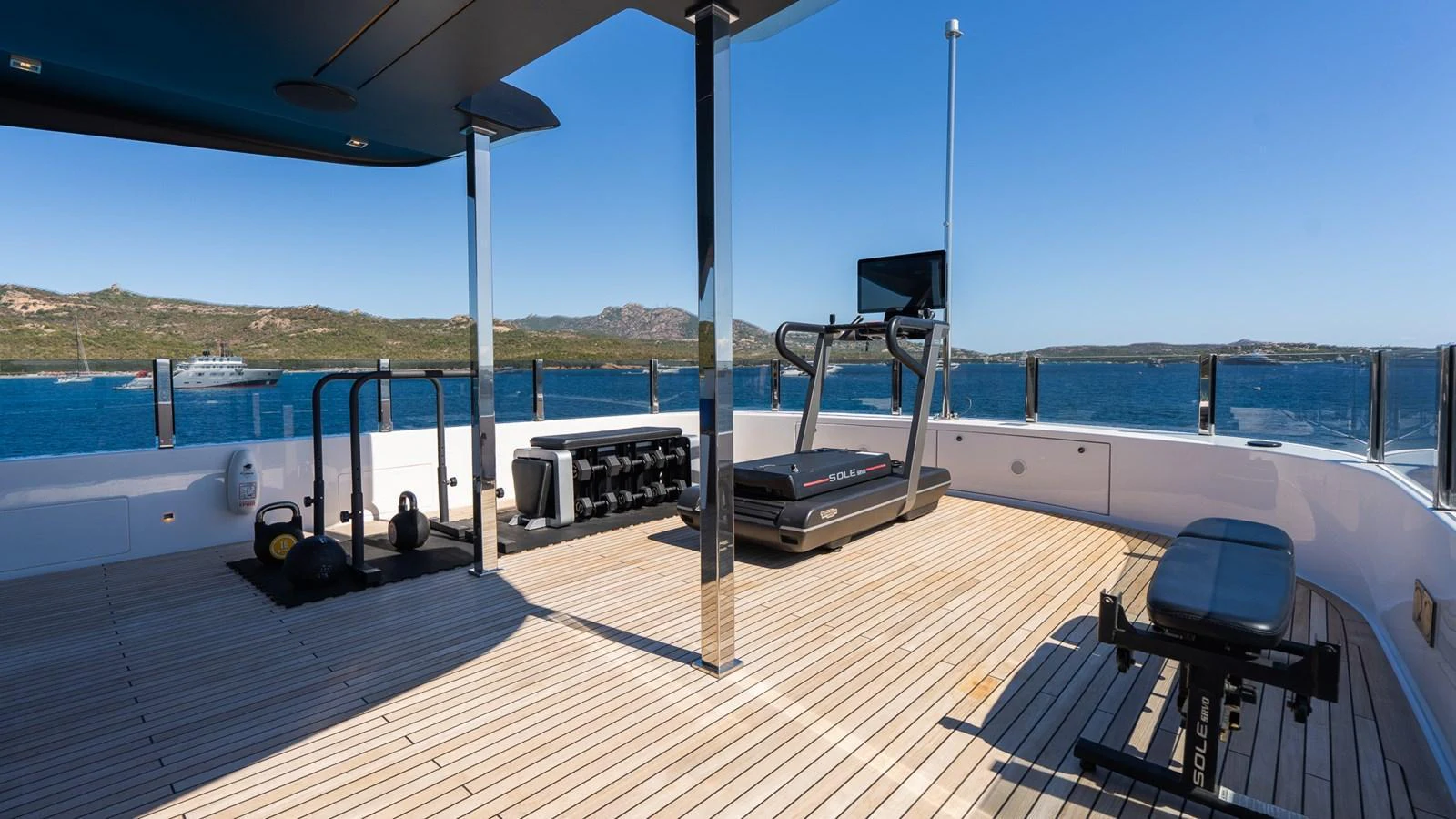 The yacht features an open-air gym with stunning sea views, equipped with modern fitness equipment. aboard QUEEN J III Yacht for Sale