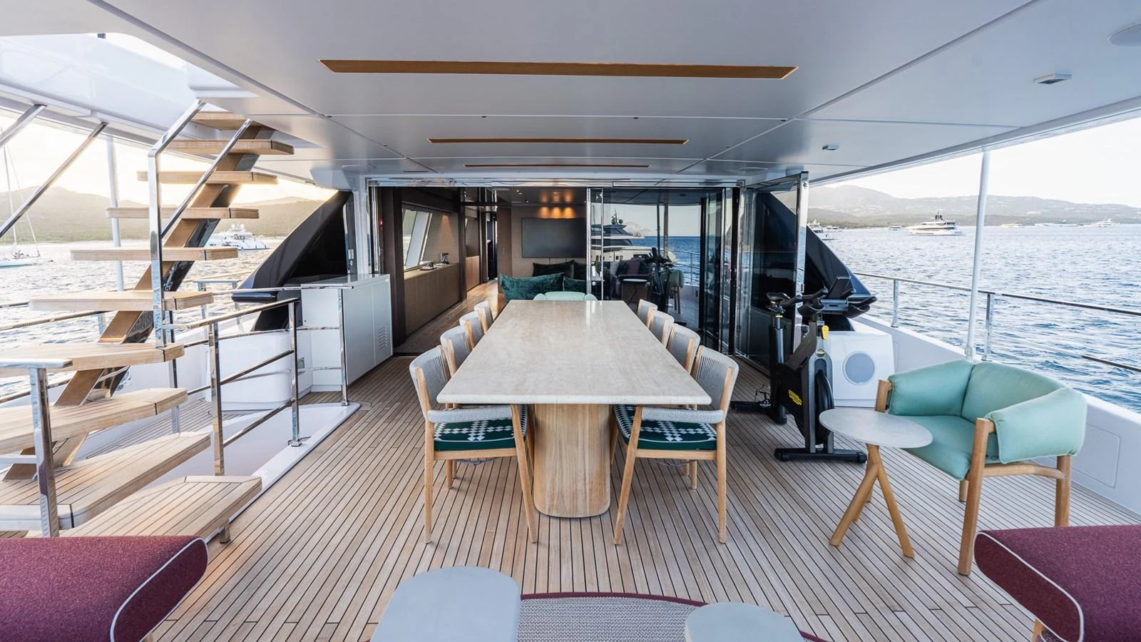 The aft deck features a spacious dining area with a large table and comfortable seating, perfect for alfresco meals. aboard QUEEN J III Yacht for Sale
