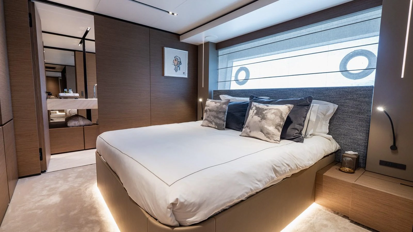 The stateroom features a plush bed with elegant bedding and modern decor, creating a serene and luxurious retreat. aboard QUEEN J III Yacht for Sale