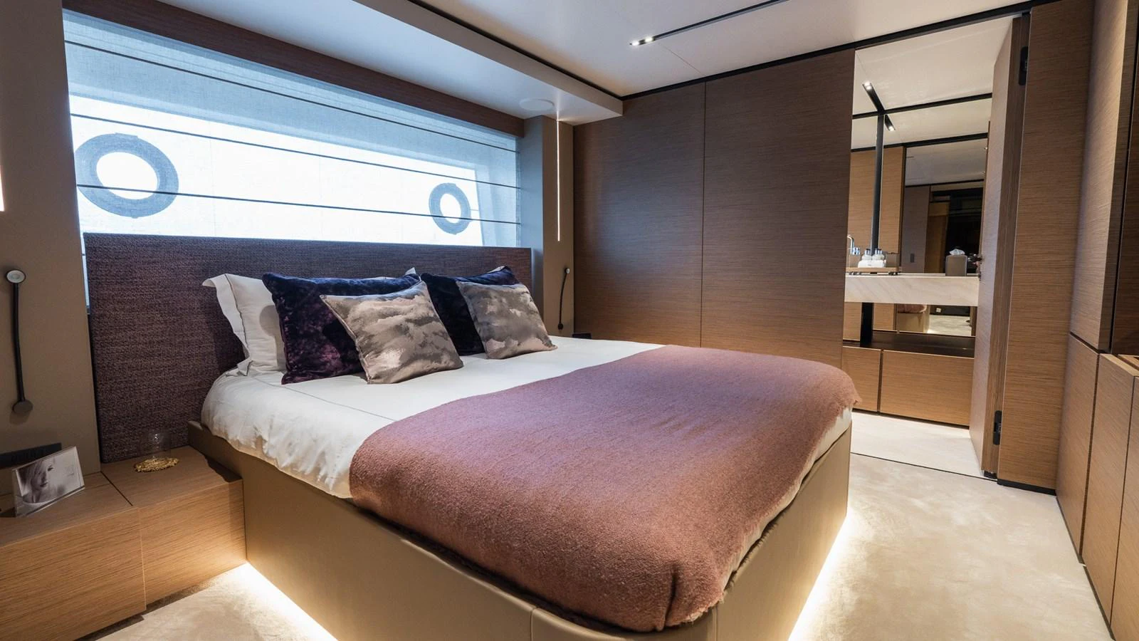 The stateroom features a luxurious bed with plush pillows and modern decor. aboard QUEEN J III Yacht for Sale
