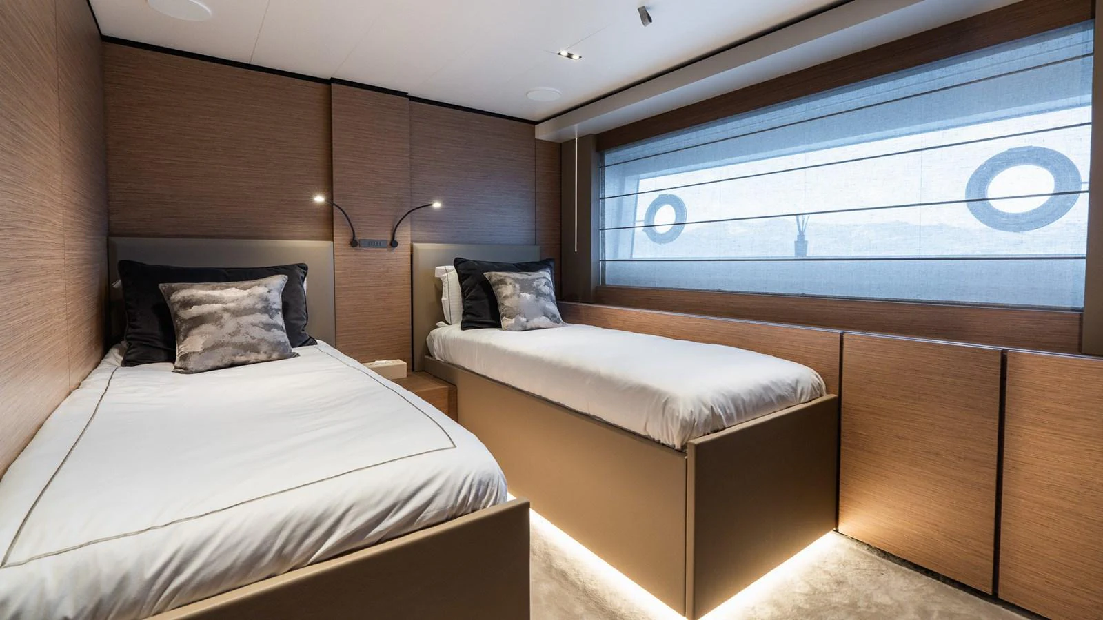 The guest stateroom features two single beds with modern decor and ample natural light. aboard QUEEN J III Yacht for Sale