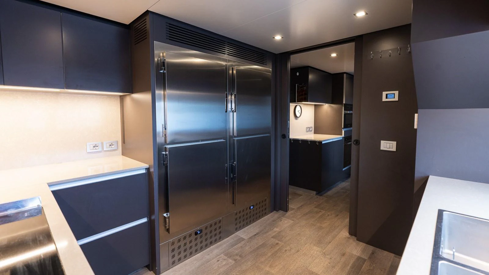 The yacht's galley features modern stainless steel appliances and sleek cabinetry, creating a sophisticated culinary space. aboard QUEEN J III Yacht for Sale