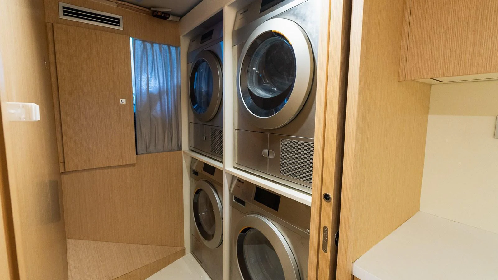 The yacht features a well-equipped laundry room with modern appliances. aboard QUEEN J III Yacht for Sale