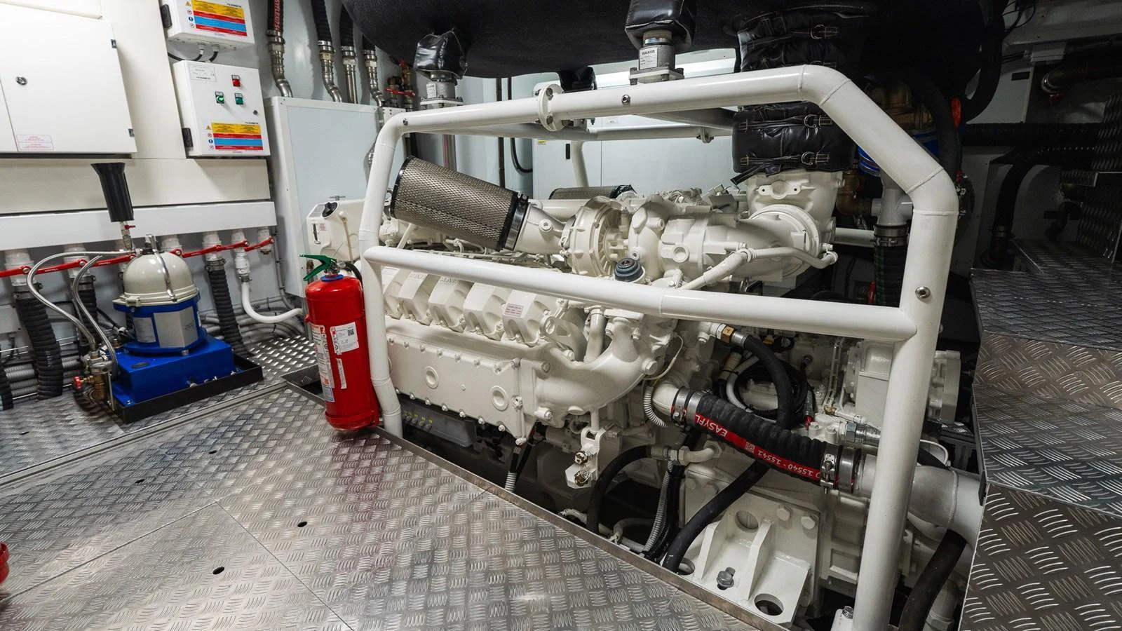The image showcases the yacht's engine room with a powerful engine and well-organized equipment. aboard QUEEN J III Yacht for Sale